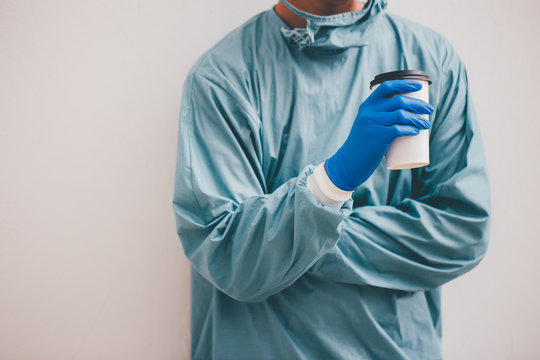 Doctor In Blue Scrubs Relaxing With Coffee Break.