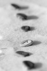 Fototapeta na wymiar Stone runes on the snow
