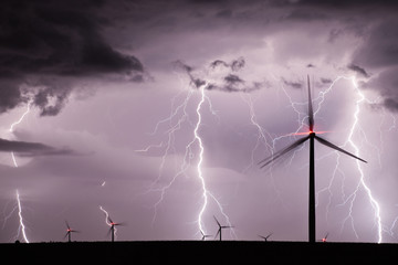 Thunderstorm with lightnings over a wind farm - 198618163