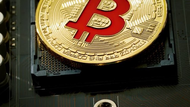 Gold Bit Coin BTC coins on the motherboard. Bitcoin is a worldwide cryptocurrency and digital payment system called the first decentralized digital currency.