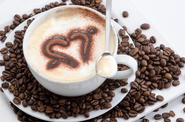 Good Morning: Close up white coffee cup on wood tab / Cup of latte art coffee with coffee beans :)