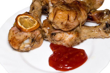 Chicken legs are with sauce on plate closeup
