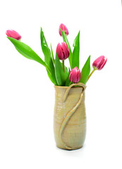 Bouquet of pink tulips in rustic vase isolated on whitr