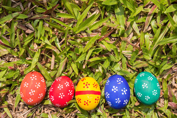 Painted Easter eggs put on the straw in the grass,easter day