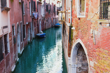 Fototapeta na wymiar Venice, Italy. Canal and old vintage colorful facades with cracked stucco.