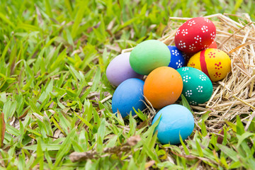 Painted Easter eggs put on the straw in the grass,easter day