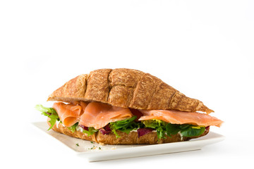 Croissant sandwich with salmon and vegetables isolated on white background

