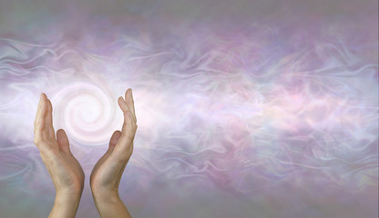Channeling Vortex healing energy  - female hands held parallel with a white spiralling vortex...