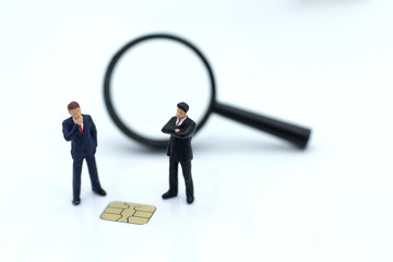 Miniature people: Businessman with a credit card chip. Image use for business concept