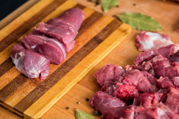 Man is cutting beef on an old board