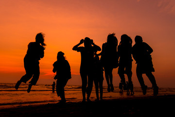 Fototapeta premium Woman is walking on the beach relaxing at sunset.
