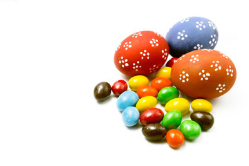 Painted Easter eggs with candy egg on white backgrou isolated