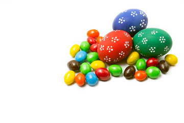 Painted Easter eggs with candy egg on white backgrou isolated