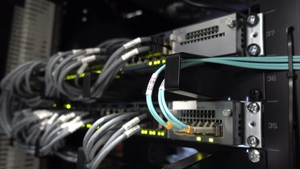 Data center flashing lights. back side of working data servers. router working. Big data center lights. has a small noise - Powered by Adobe