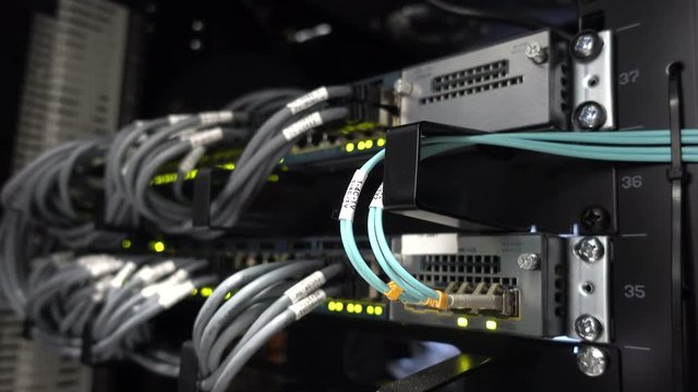 Data center flashing lights. back side of working data servers. router working. Big data center lights. has a small noise