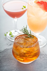 Variety of citrus cocktails on gray surface