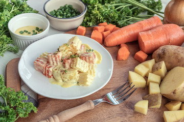 Traditional German potato salad with carrot, onion and mayonnaise.
