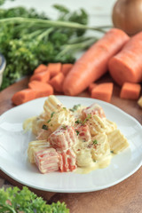 Traditional German potato salad with carrot, onion and mayonnaise.