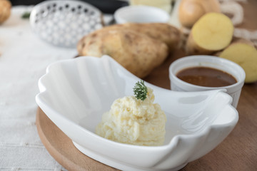 Mashed potatoes with chives served in a small bowl