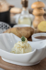 Mashed potatoes with chives served in a small bowl