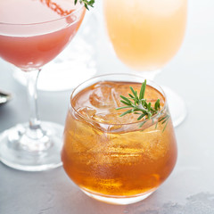 Variety of citrus cocktails on gray surface