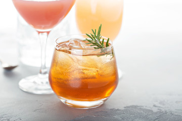 Variety of citrus cocktails on gray surface