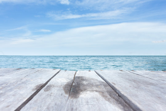 Fototapeta Perspective of wood terrace against beautiful seascape