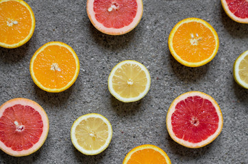 Fototapeta na wymiar Citrus tropical fruits halves flatlay pattern