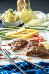 steak with vegetables, fries and barbecue sauce