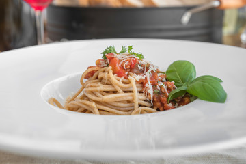 Close up low angle view of a plate of spaghetti topped with delicious bolognaise sauce