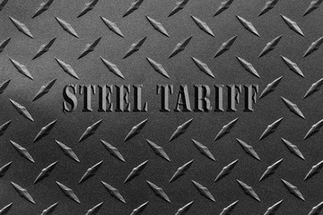 Words steel tariff written on textured steel sheet with diamond plate pattern/USA steel tariff...