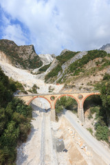 Landscape of Carrara's marble quarry in Tuscany (Italy) with the distinctive bridge in the locality Ponti di Vara