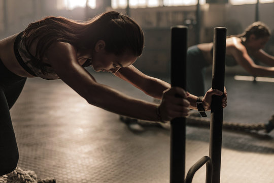 Women doing intense physical workout in gym