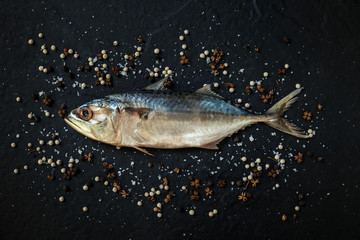 Fresh, raw mackerel on a black background.