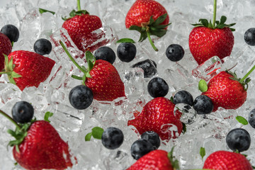 Obraz na płótnie Canvas Strawberry with blueberries on ice