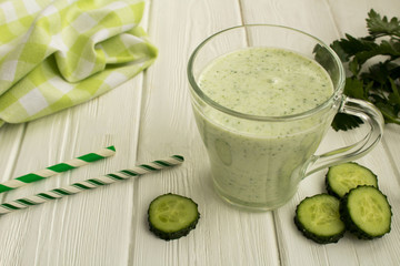 Yogurt smoothie  with  cucumber on the white wooden background