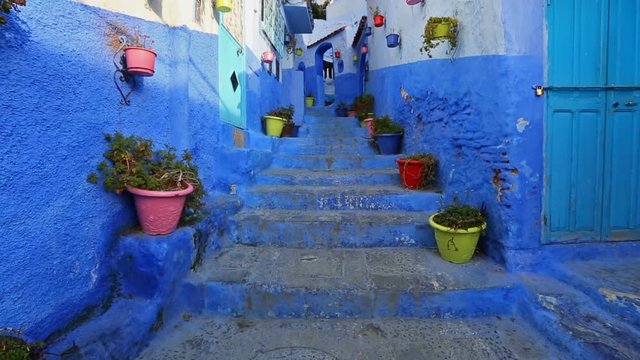Traditional old blue street with color pots inside Medina of Chefchaouen, Morocco
