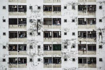 Background and Wallpaper or Texture of Condominium Building facade. With people living. With balcony and window. Old building and dilapidated. at Thailand