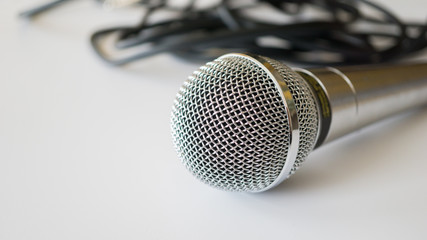 Silver handheld ballhead microphone on light background