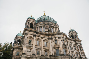 Fototapeta na wymiar The Berlin Cathedral is called Berliner Dom. Beautiful old building in the style of neoclassicism and baroque with cross and sculptures.