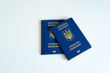 New ukrainian blue biometric passport with identification chip and old ukrainian passport on white background