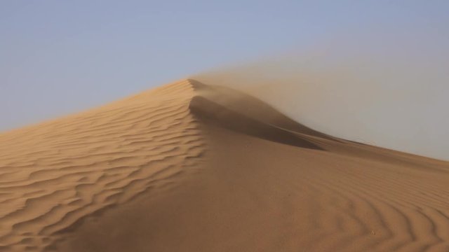 Sand blowing over sand dunes in wind, Sahara desert, 4k
