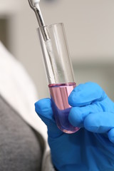 the tube with pink liquid