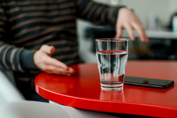 Glass of water on a red table