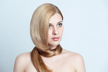 Fototapeta premium pretty blonde girl with long beautiful hair around her neck