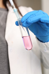 the tube with pink liquid