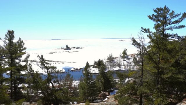 Georgian Bay Thirthy Thousand Islands panning view from Chikanishing Trail in Killarney Provincial Park of Ontario in winter