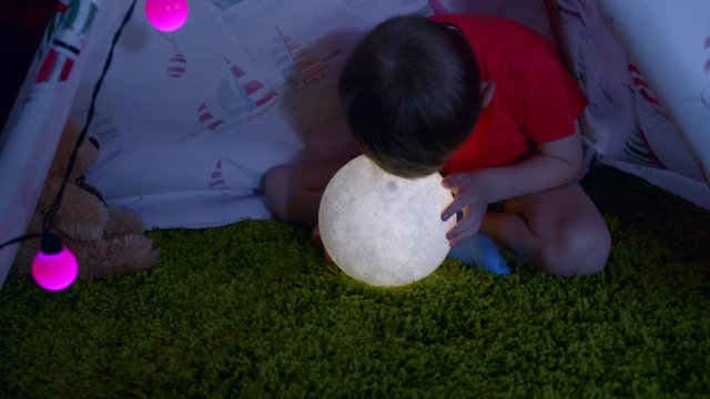 Little boy is watching the moon