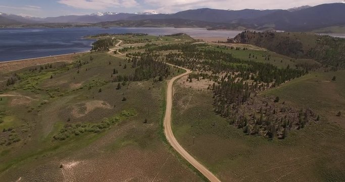 flying high over road back to grand lake granby - Drone Aerial Video 4K Colorado Rocky Mountains, Colorado river, Mountain dam at lake granby,  beautiful water reflection, spring, pristine water