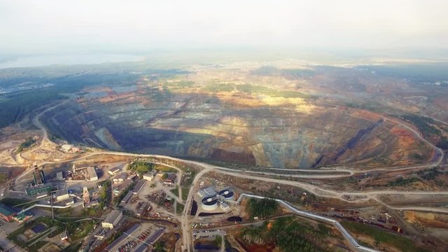 Aerial view industrial of opencast mining quarry with lots of machinery at work - view from above. Extraction of gold, copper
